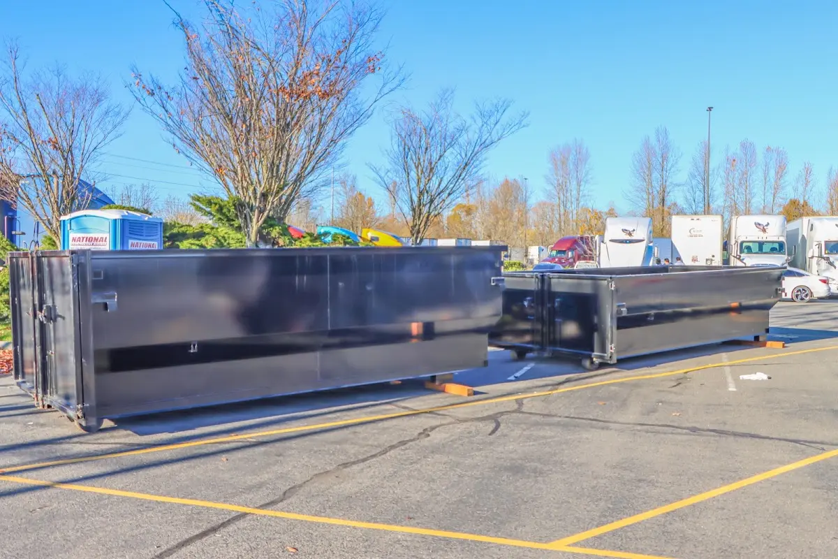 Professional dumpster rental service with roll-off container on residential driveway in Rio Pinar